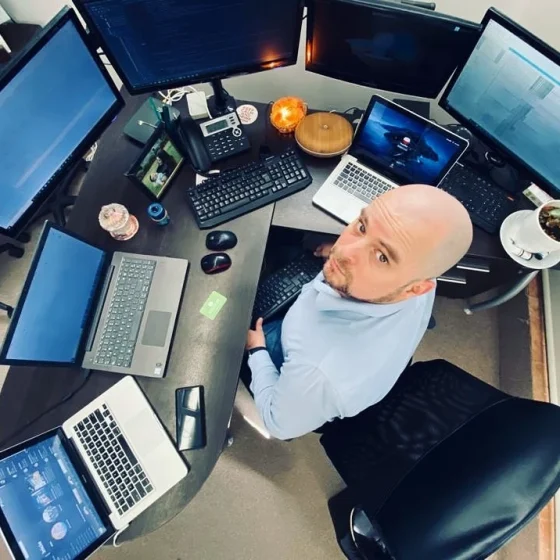 Mario with many computers on his workspace